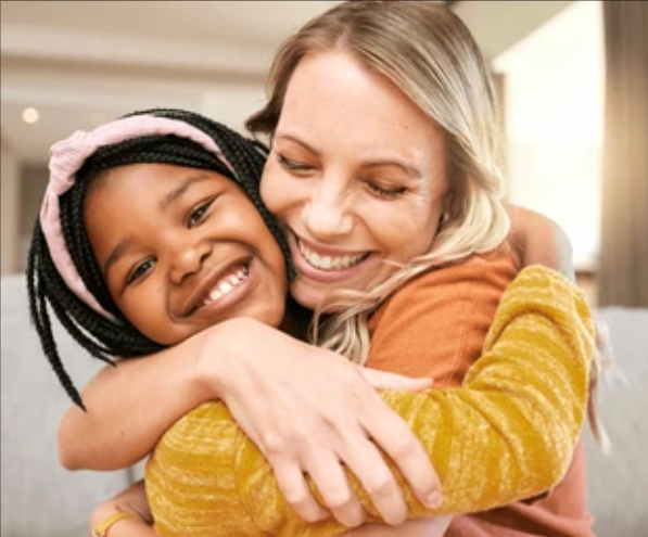 Mother hugging daughter
